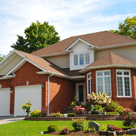 Beautiful brick suburban home with landscaped yard
