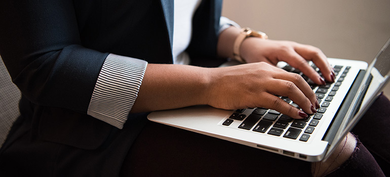 Woman typing on a laptop